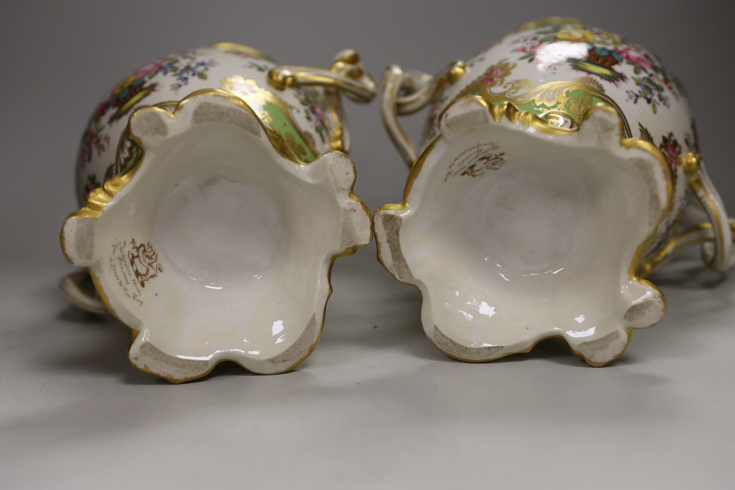 A pair of Rockingham style porcelain pot pourri vases, each of rococo form painted to each side with baskets of flowers, rare brown printed Rockingham griffin mark, 29cm high